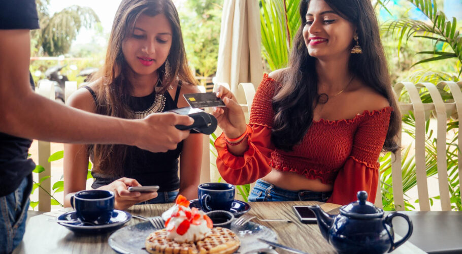 female customer paying coffee pancakes with credit card waiter payment terminal while client doing contactless purchase cafe in china