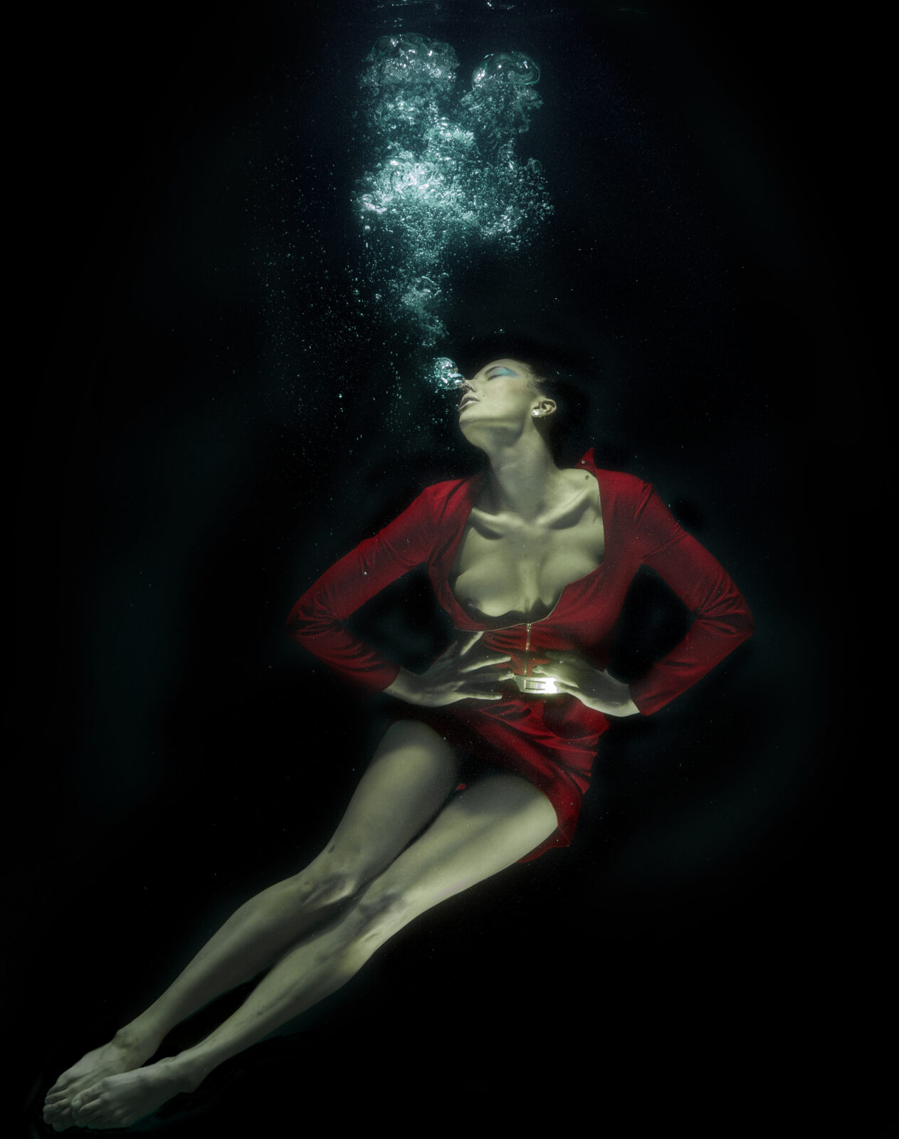 woman in red dress submerged in water fantasy fine art