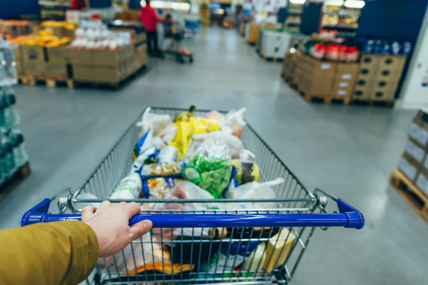 first person view man with trolley grocery store shopping