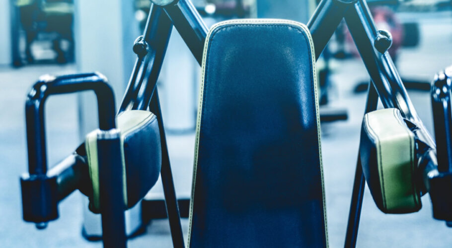 fitness bodybuilder machine shoulders at the gym
