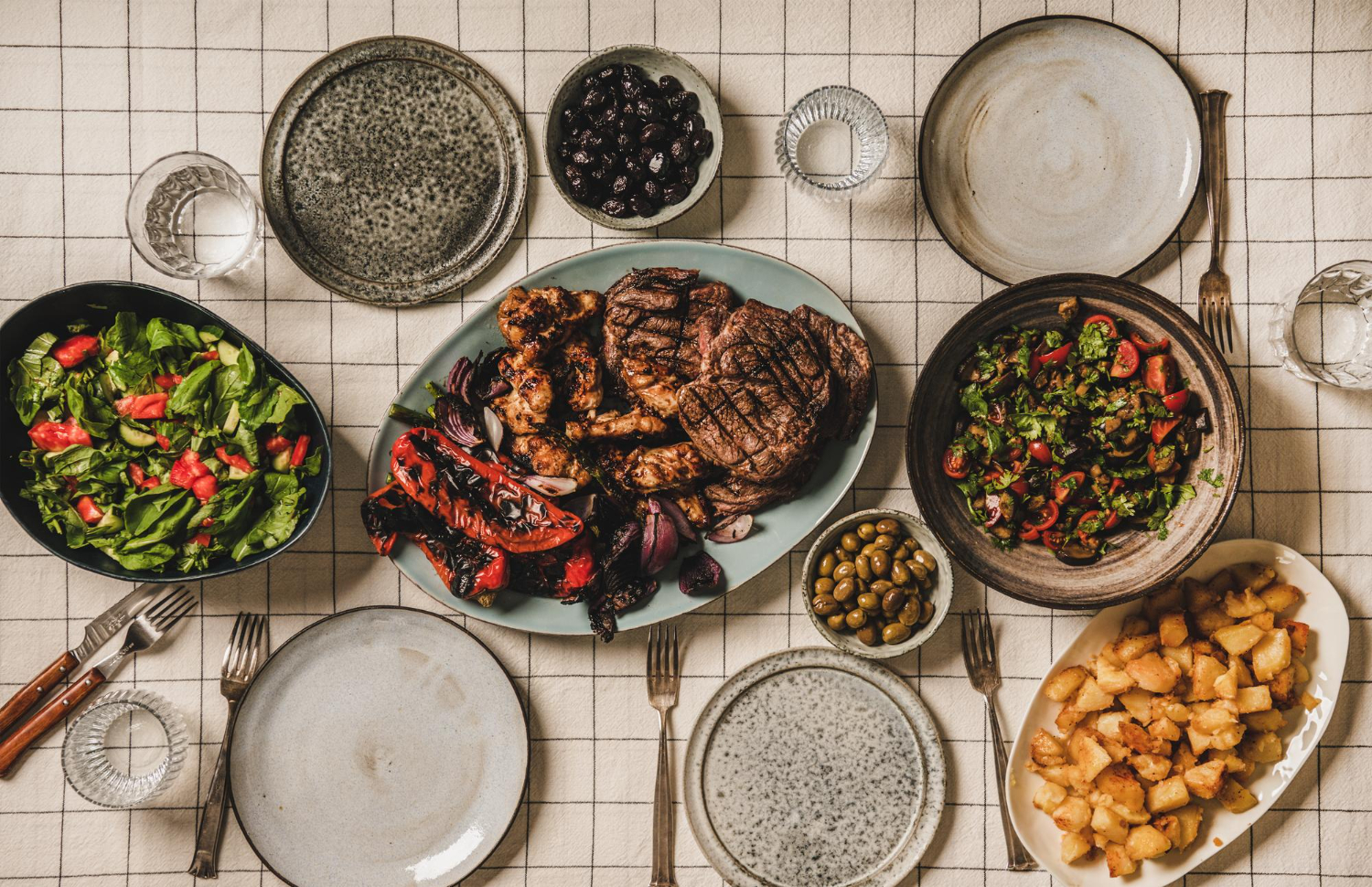 flatlay table with grilled meat chicken vegetables salads potato