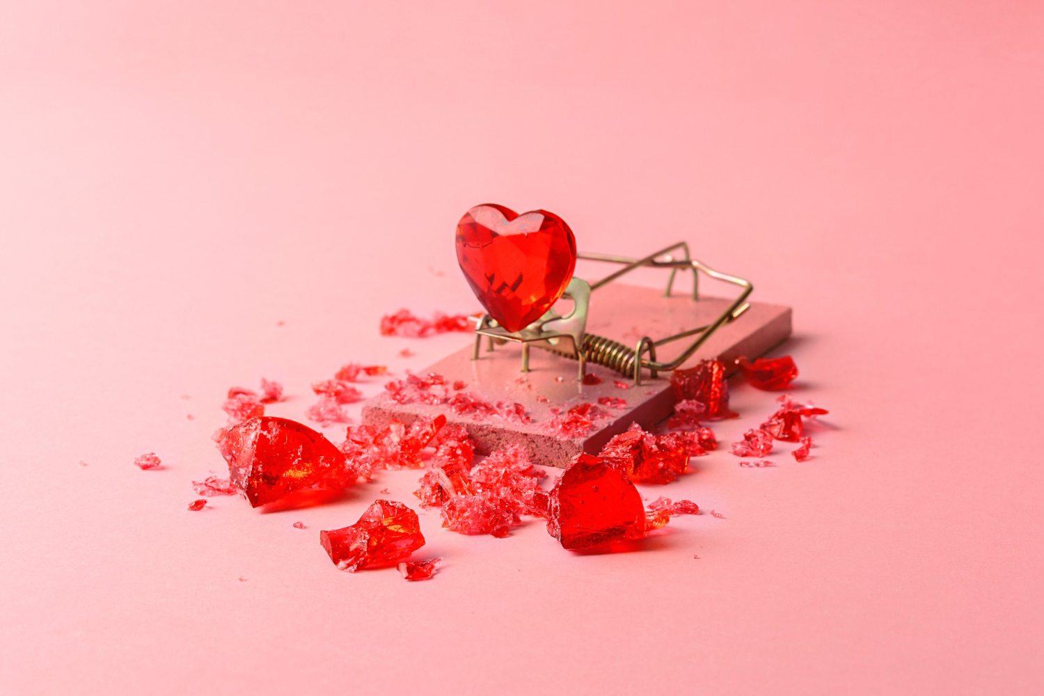 glass heart mousetrap pink background creative concept valentines day