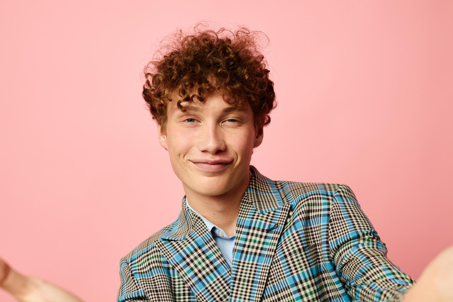 male with red curly hair business look in suit smiling happy emotions