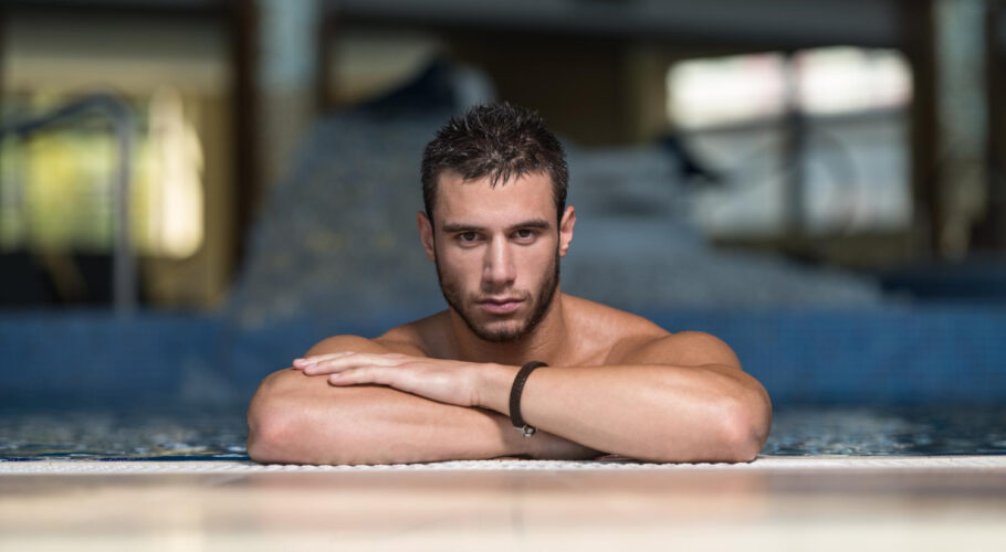 happy attractive man resting relaxed edge swimming pool