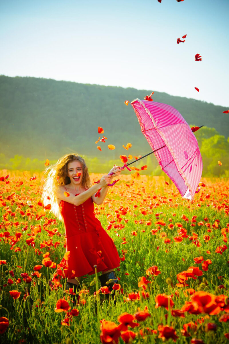 happy girl with pink umbrella red poppyfield