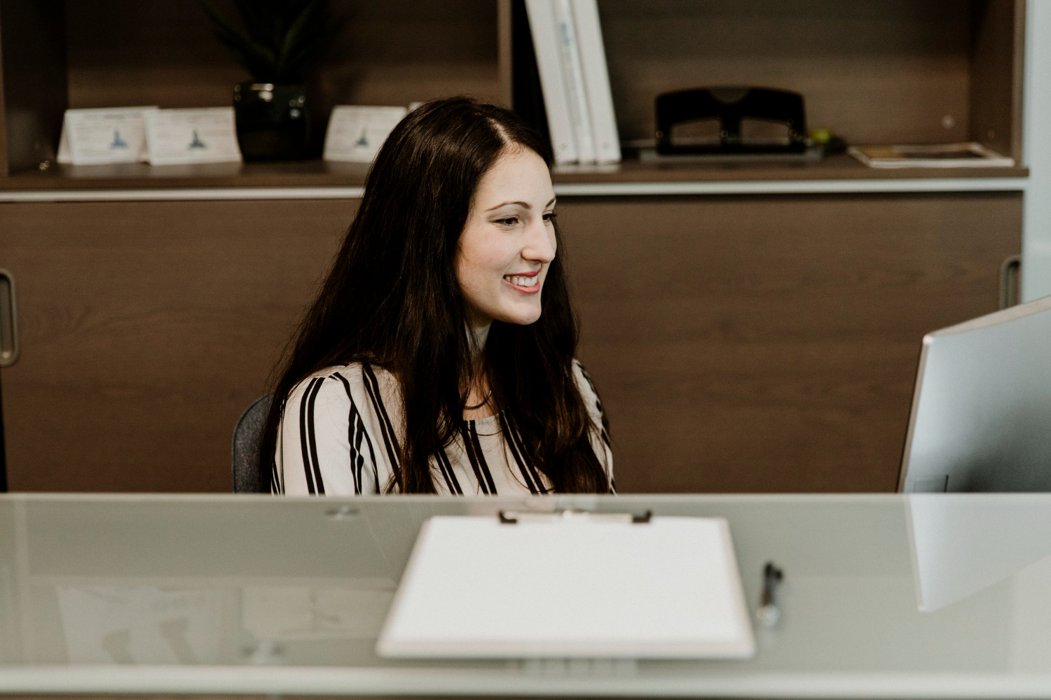 happy receptionist workingcomputer