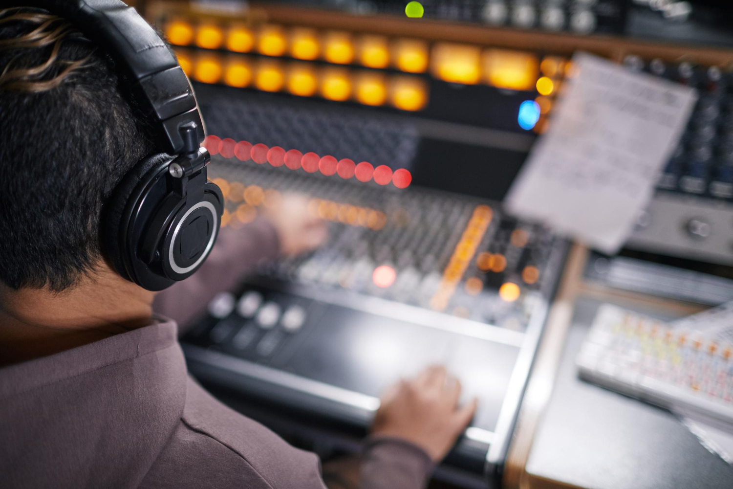 high angle view music producer wearing headphones audio workstation professional recording