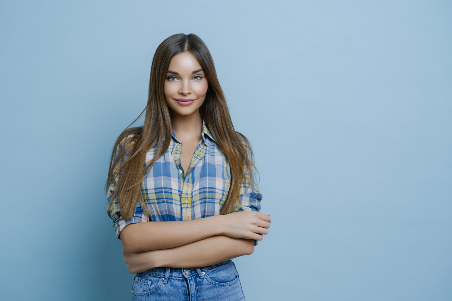 horizontal shot attractive young female with long straight hair wears checkered shirt jeans keeps hands valerie