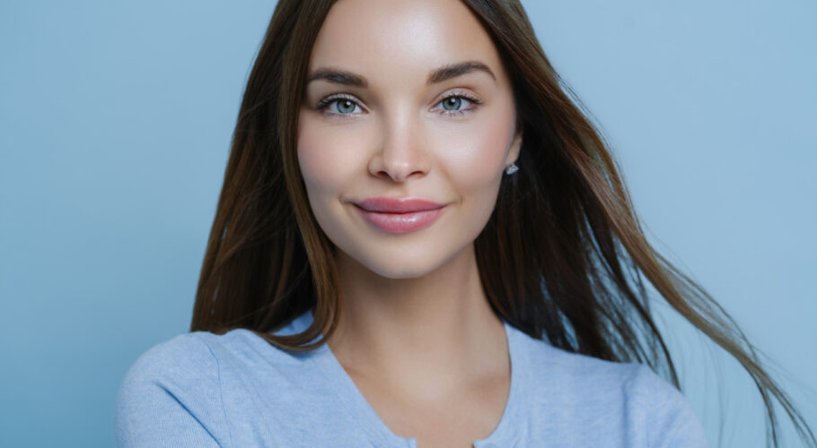 young woman with straight dark brunette hair with fresh makeup look