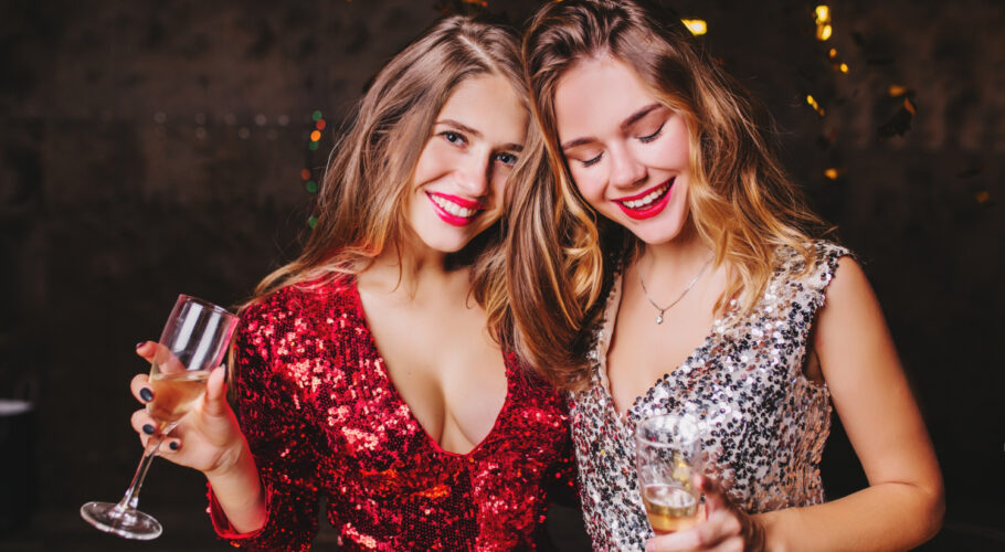 indoor clubbing young girls trendy in sparkle attire enjoying a party
