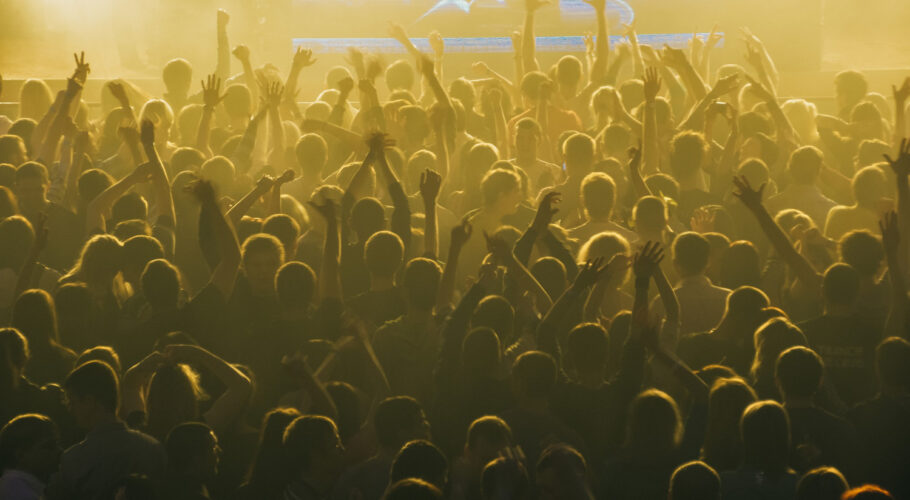 large crowd people stadium concert dark