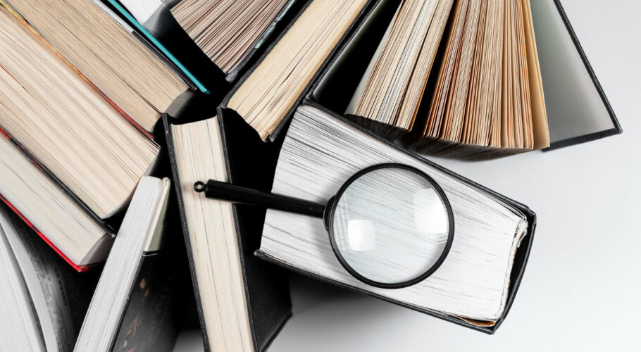 magnifying lens different books concept focusing knowledge studying
