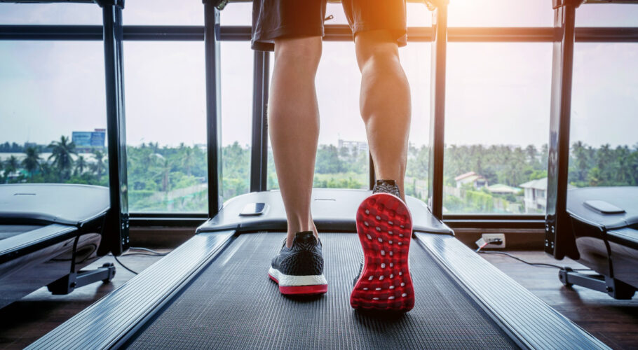 male feet sneakers running treadmill gym exercise