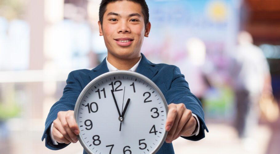 asian chinese man holding big clock time