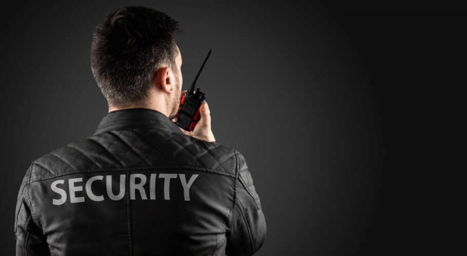man security is holding walkie talkie shopping center mall