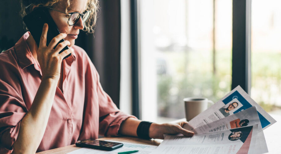 Recruitment Agency Consultant Looking Through Many Different CVs