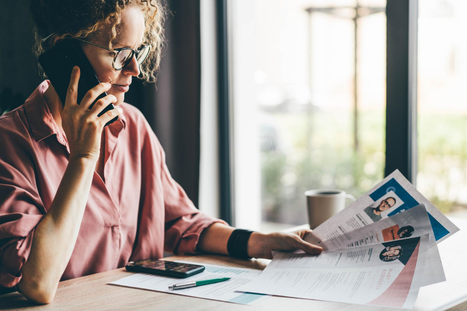 Recruitment Agency Consultant Looking Through Many Different CVs