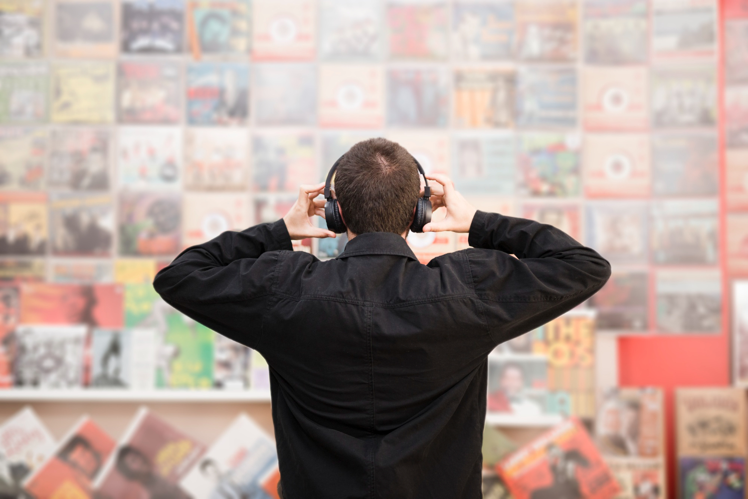 young man listening to music in CD store