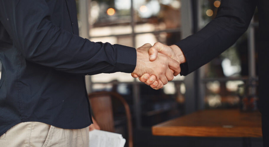 men shake hands enclosure business agreement understanding business partners