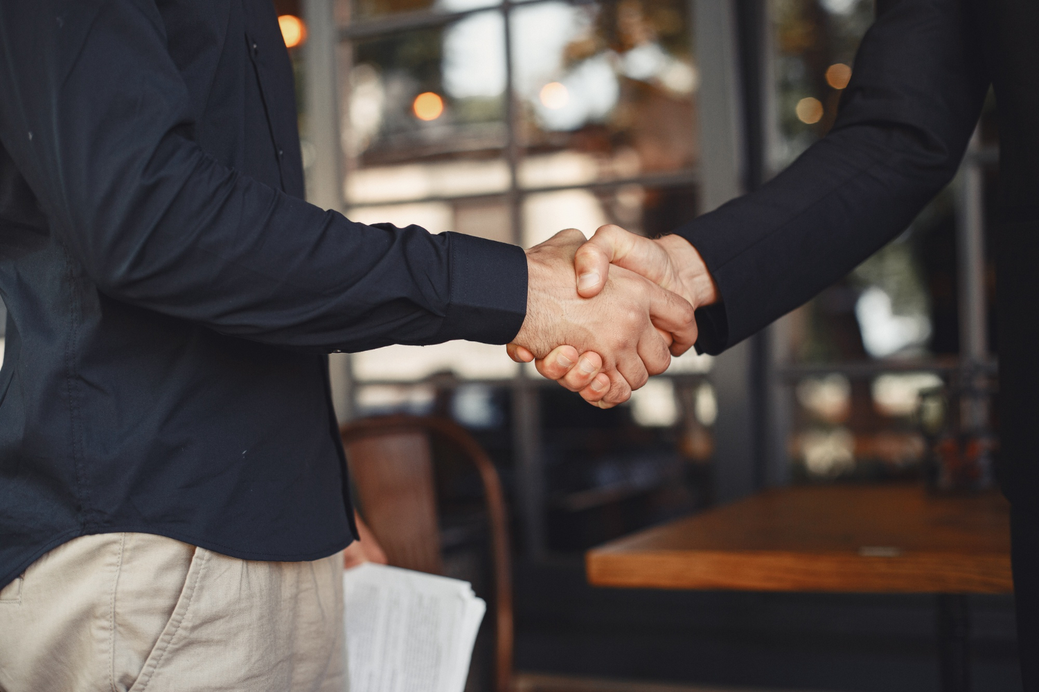 men shake hands enclosure business agreement understanding business partners