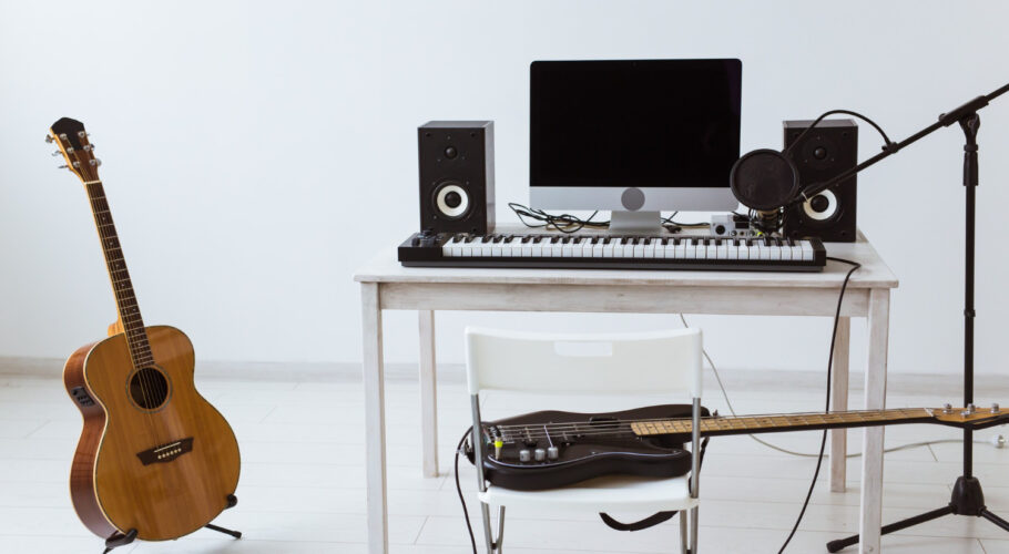 microphone computer guitars and music equipment set up for home recording studio