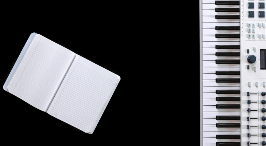 music notepad top view with musical keyboard writing music score