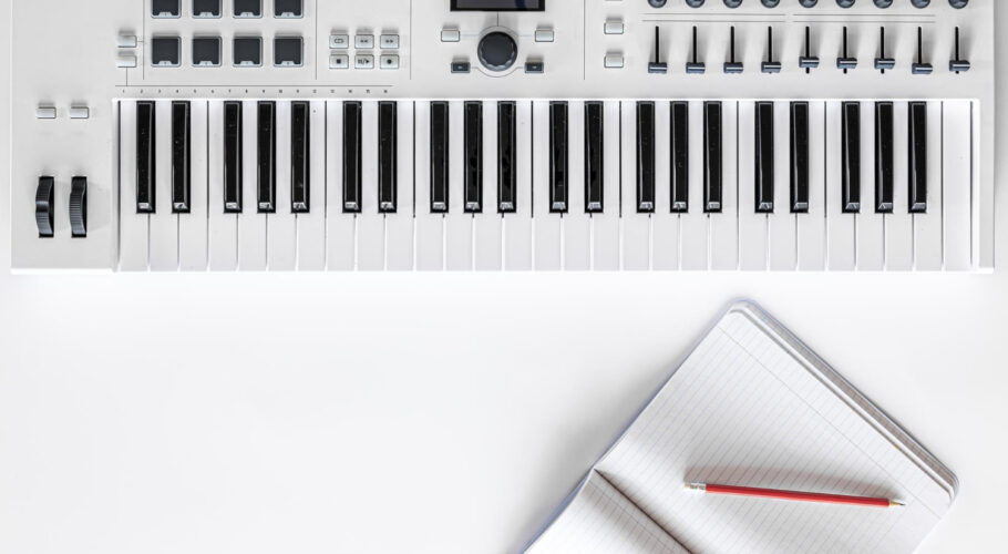 musical piano keyboard and notepad with musical keys