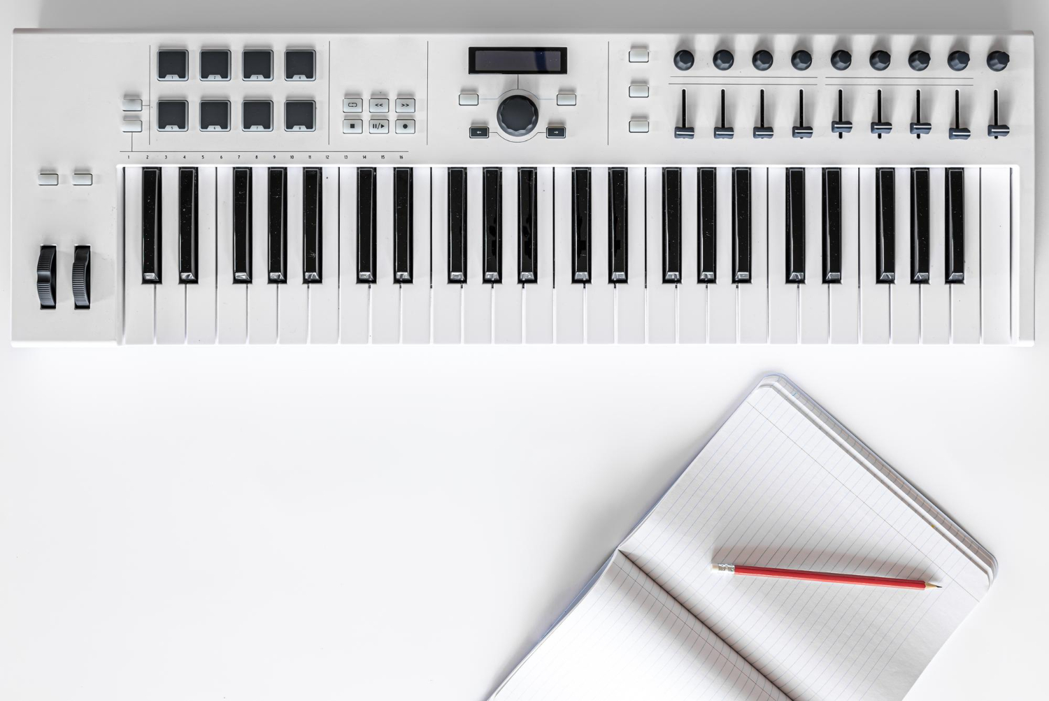 musical piano keyboard and notepad with musical keys