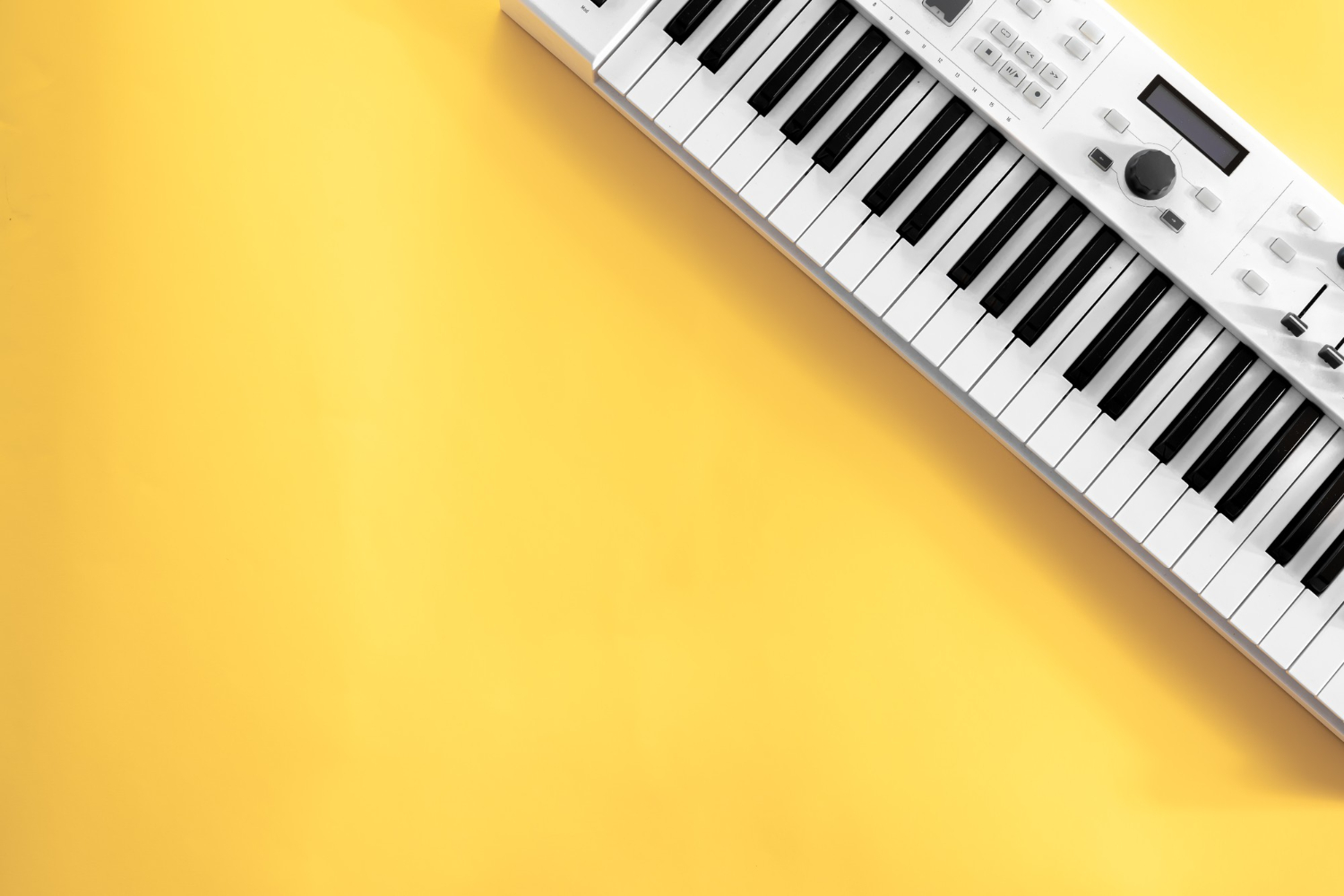 musical background with musical keys yellow flat lay