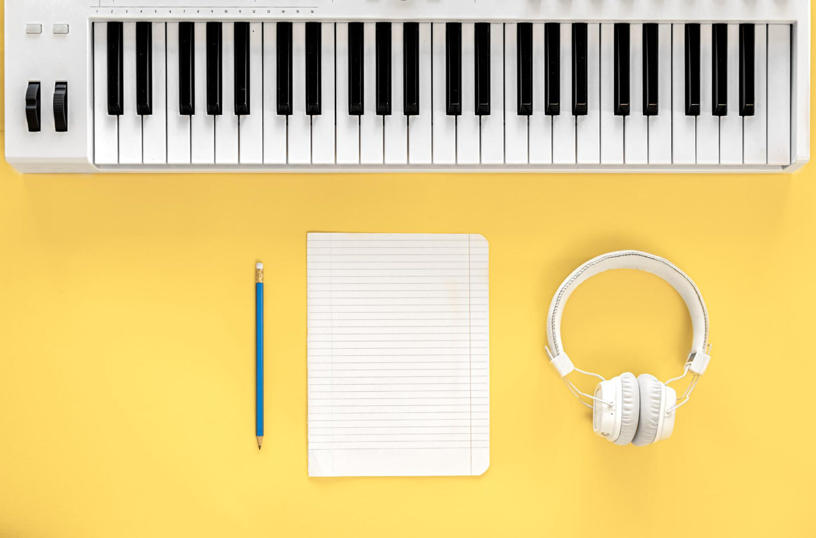 musical flat lay background with headphones musical keys create write music