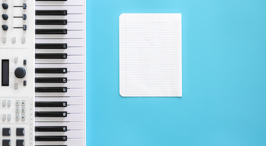 musical keys and blank paper writing music being creative