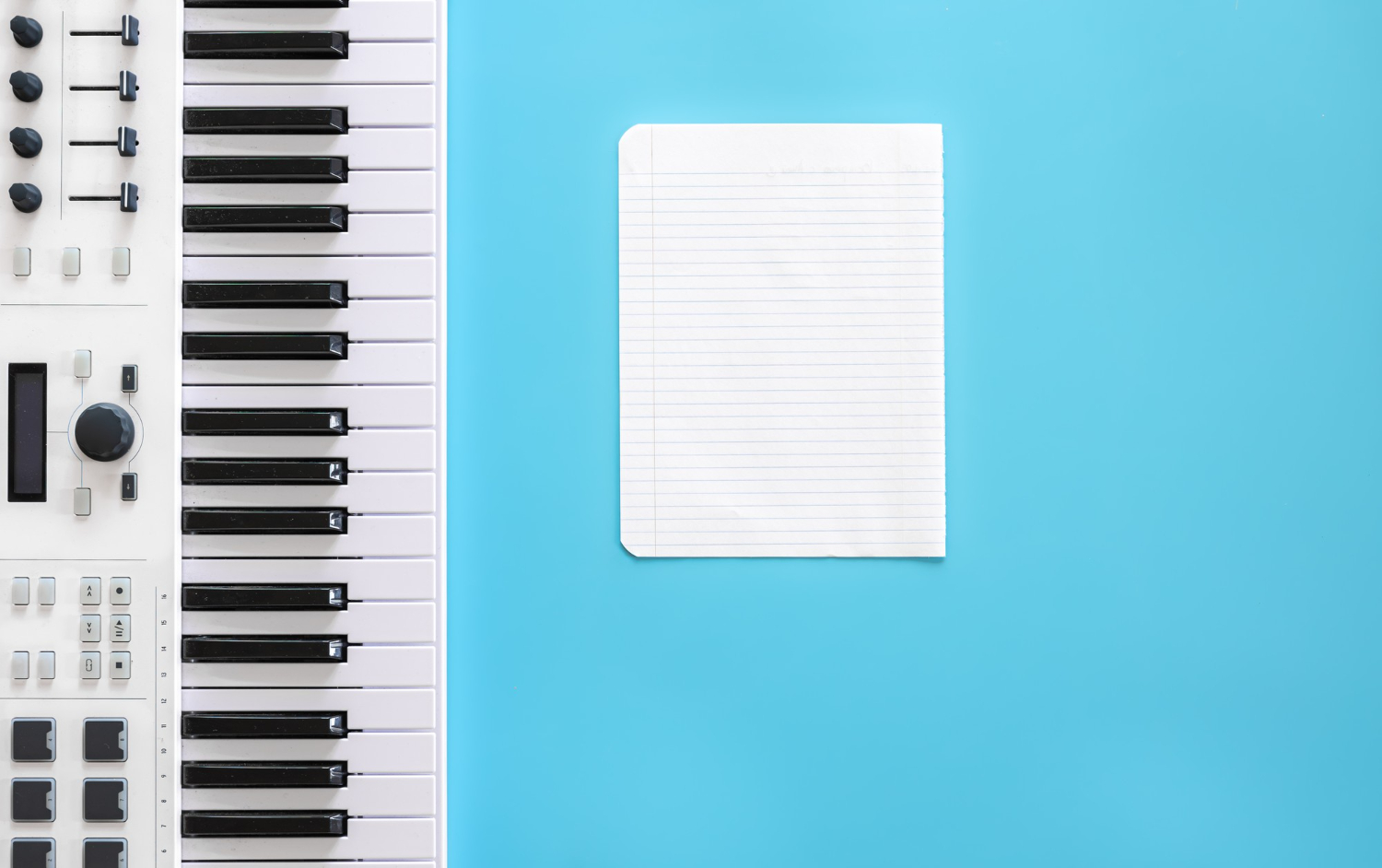 musical keys and blank paper writing music being creative