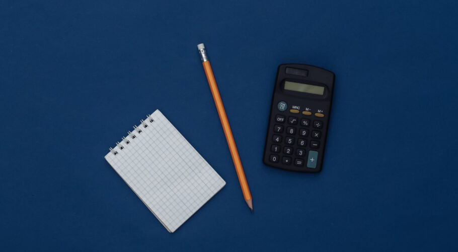 notepad with pencil and calculator gadgets on blue background