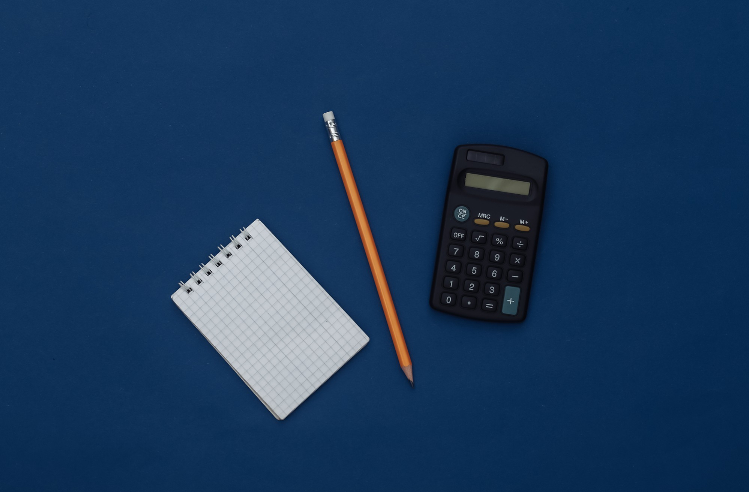 notepad with pencil and calculator gadgets on blue background