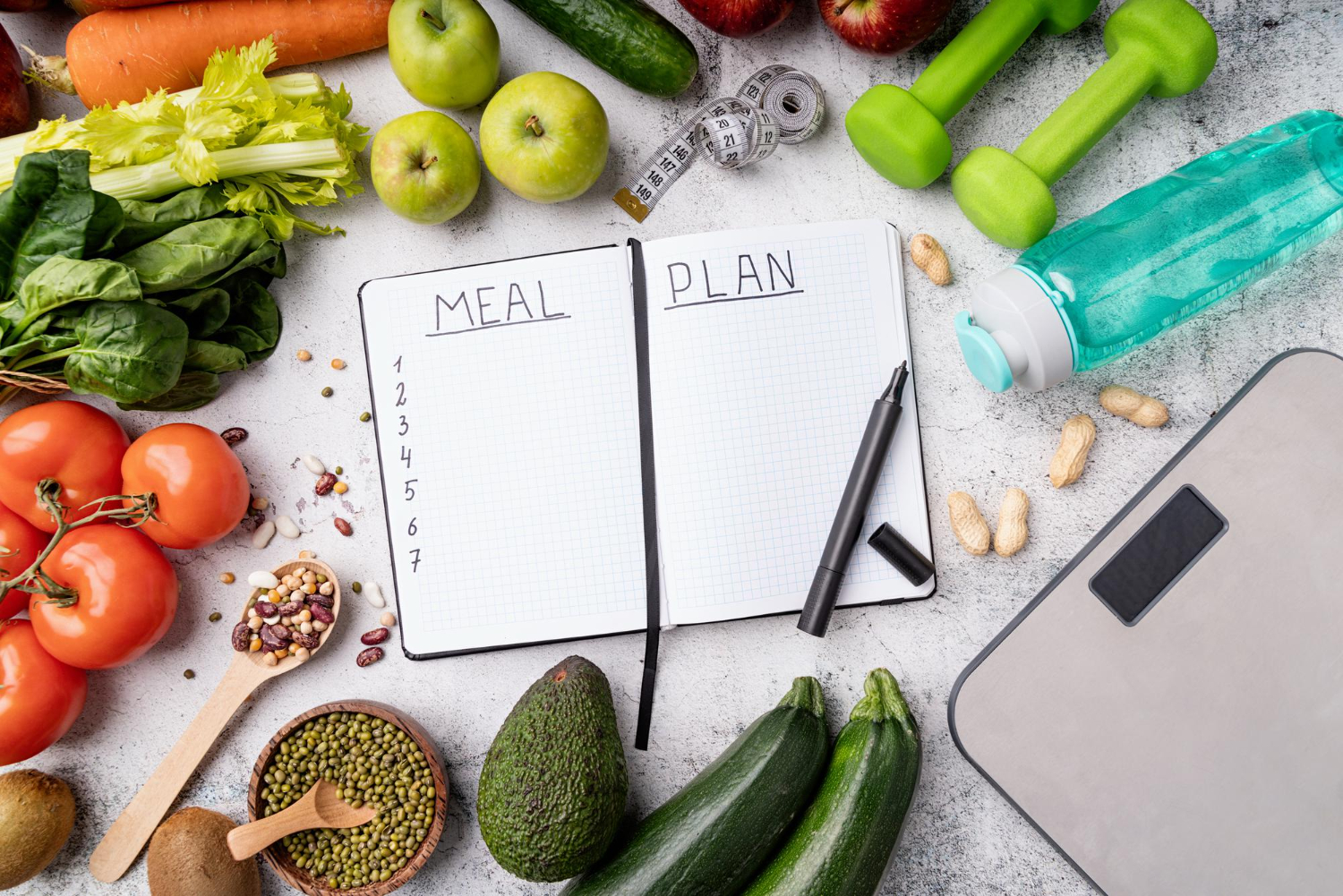 meal plan notepad with healthy sports food and equipment