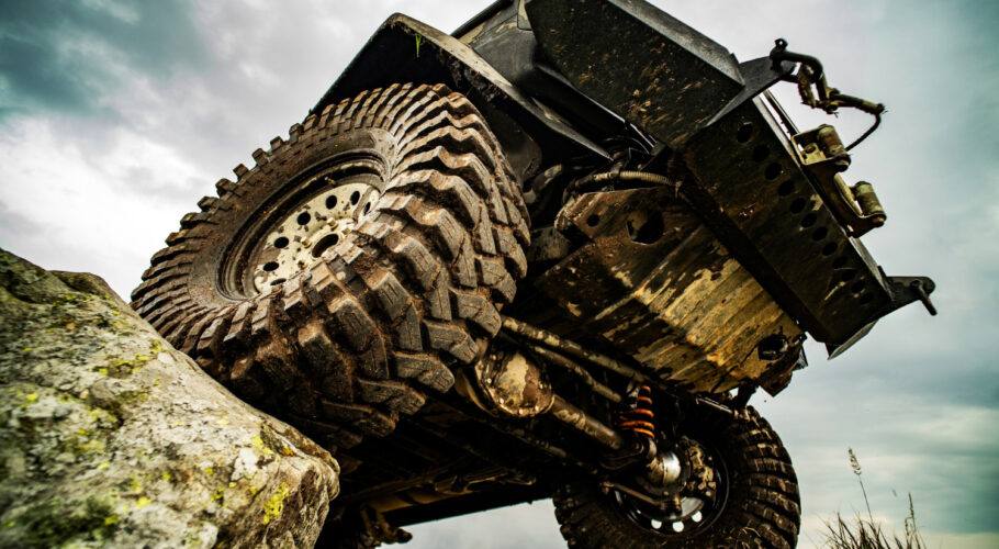 off road car driving in mud on mountain road offroad