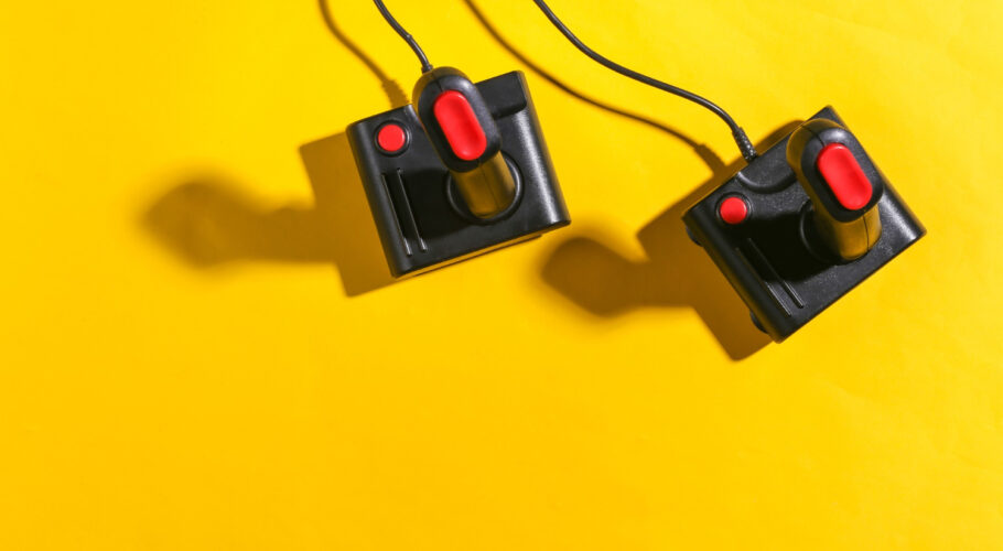 amiga 500 old joysticks yellow background with shadow retro gaming top view
