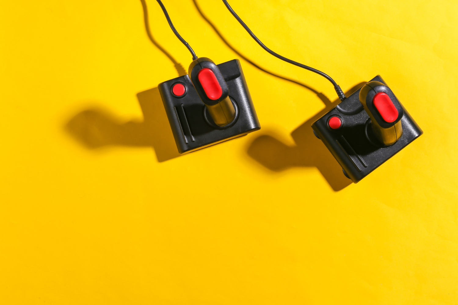 amiga 500 old joysticks yellow background with shadow retro gaming top view