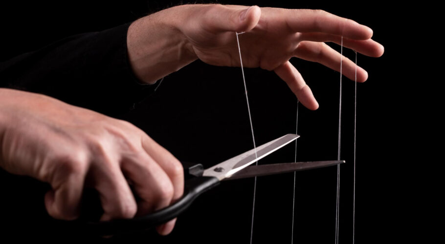 overcoming addiction man cutting strings fingers with scissors getting rid bad habits