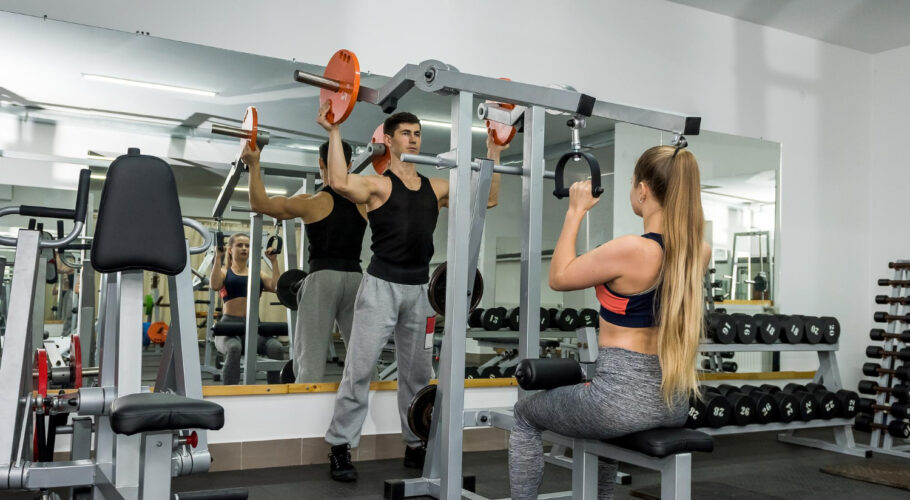 personal trainer working with young beautiful woman