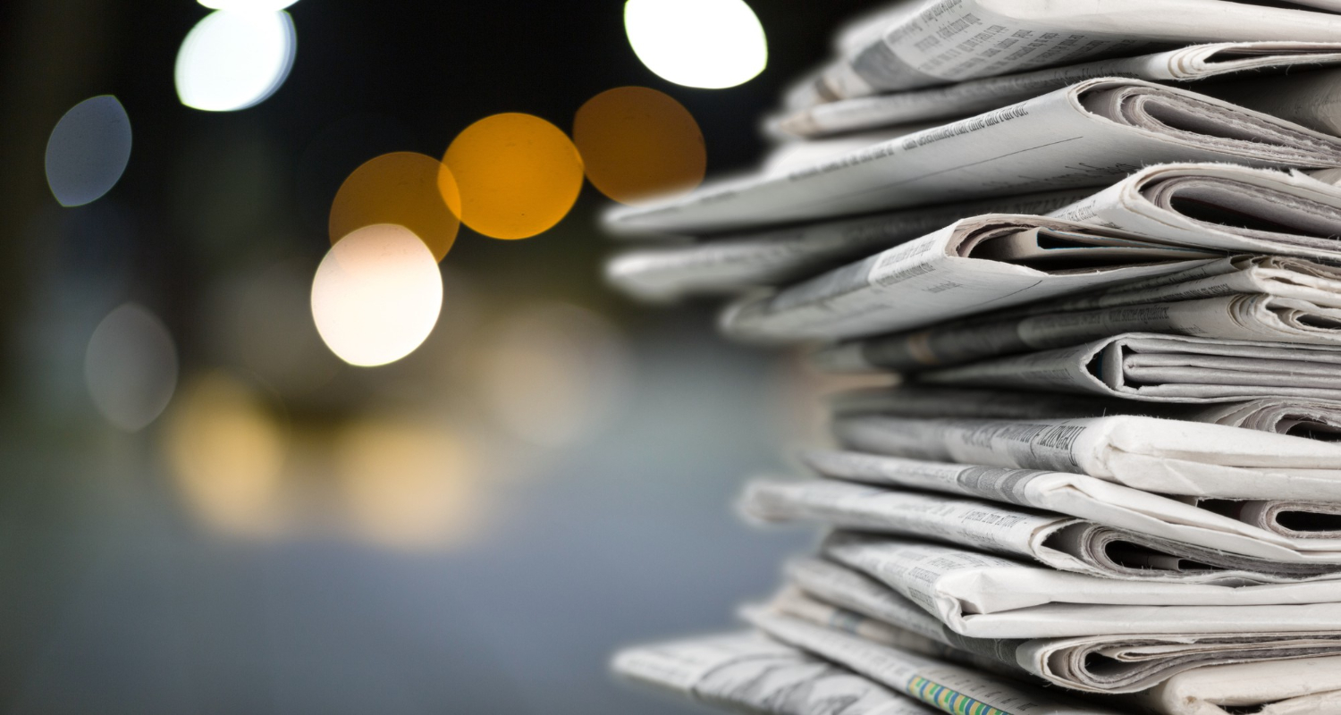 pile of stolen newspapers on nighttime background