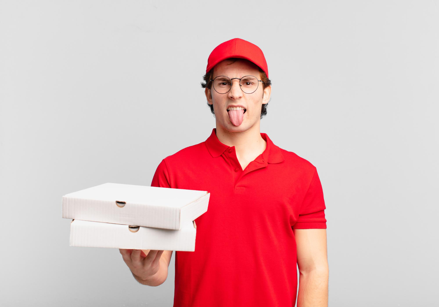 pizza hut delivery boy feeling irritated sticking his tongue out disliking something nasty