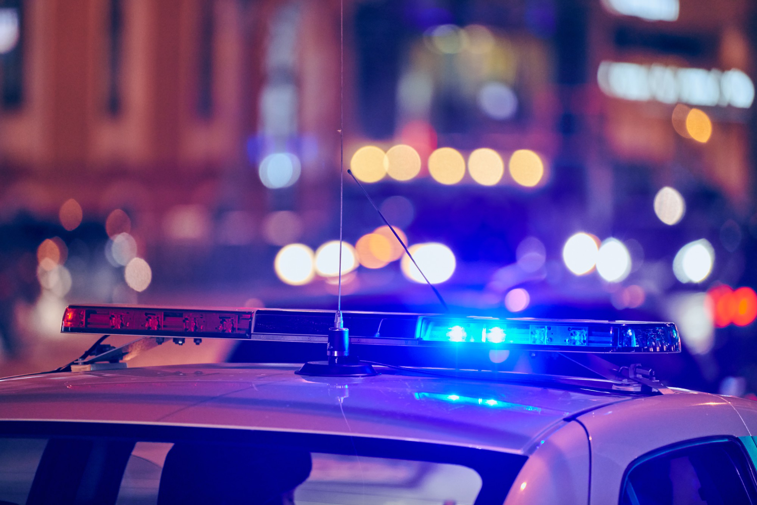 police car lights at night on city street red and blue lights