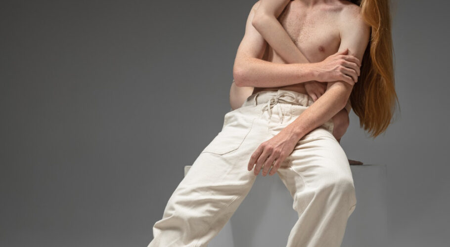 beautiful redhead ginger couple with man being defended and pulled away by the pretty female