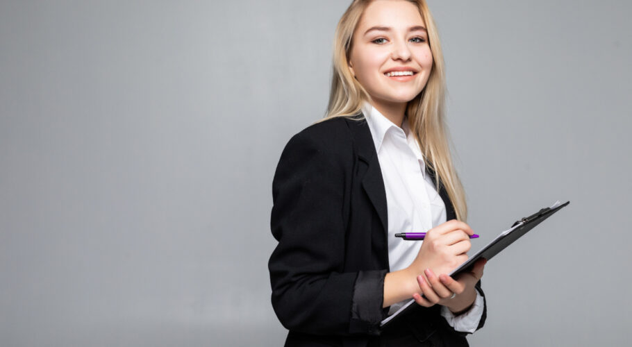 portrait woman holding clip board hands writing paper wearing glasses job interview