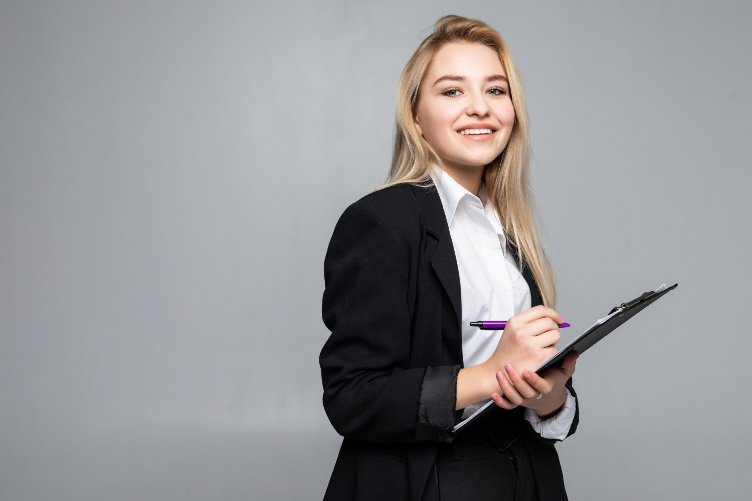 portrait woman holding clip board hands writing paper wearing glasses job interview