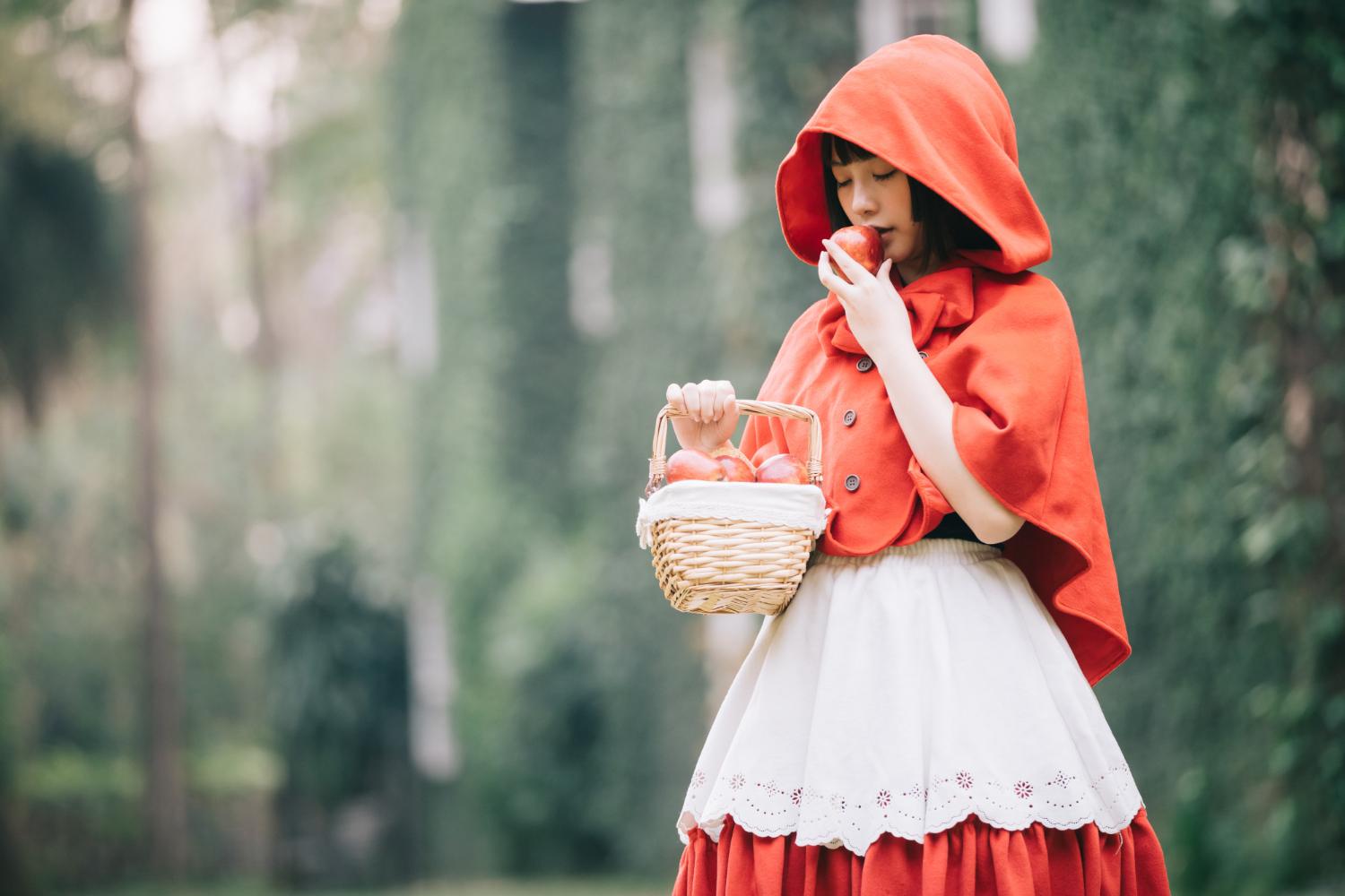 young Asian woman with little red riding hood clothes feeling safe or in danger