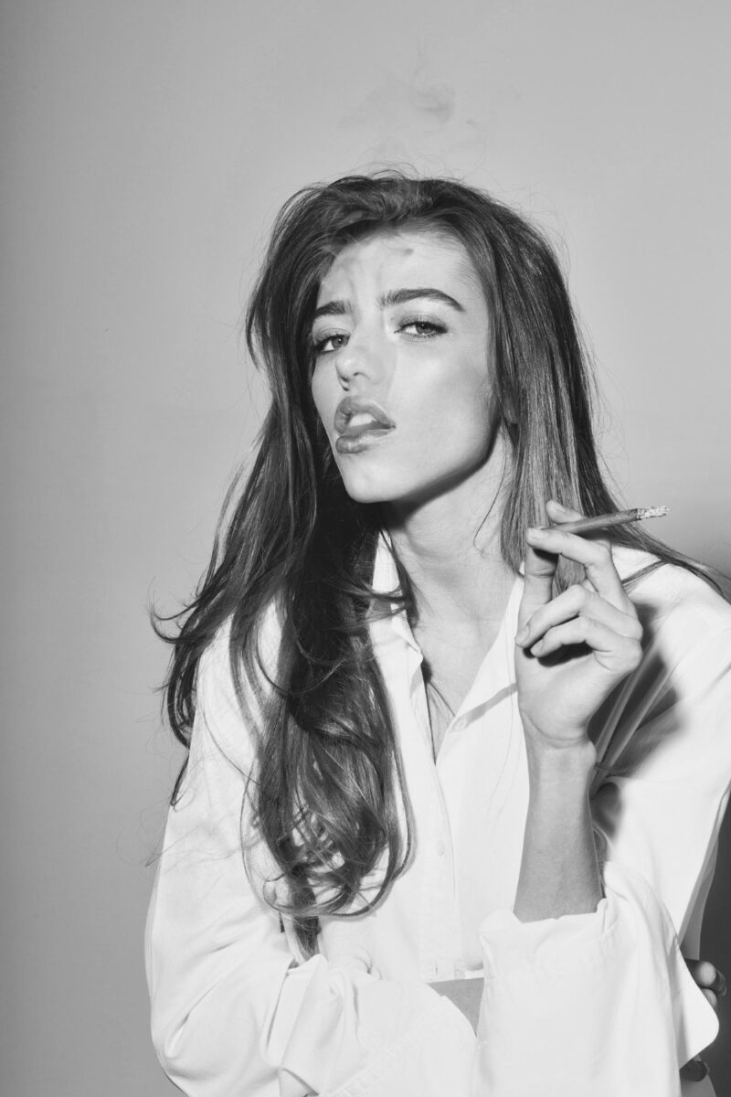 pretty sexy woman girl with long hair smoking cigarette