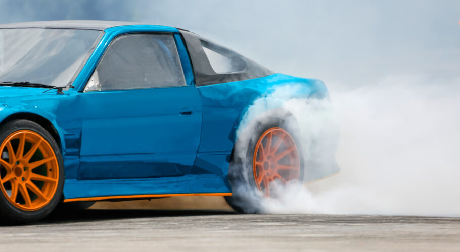 race car drifts burning tires on a speed track drag racing