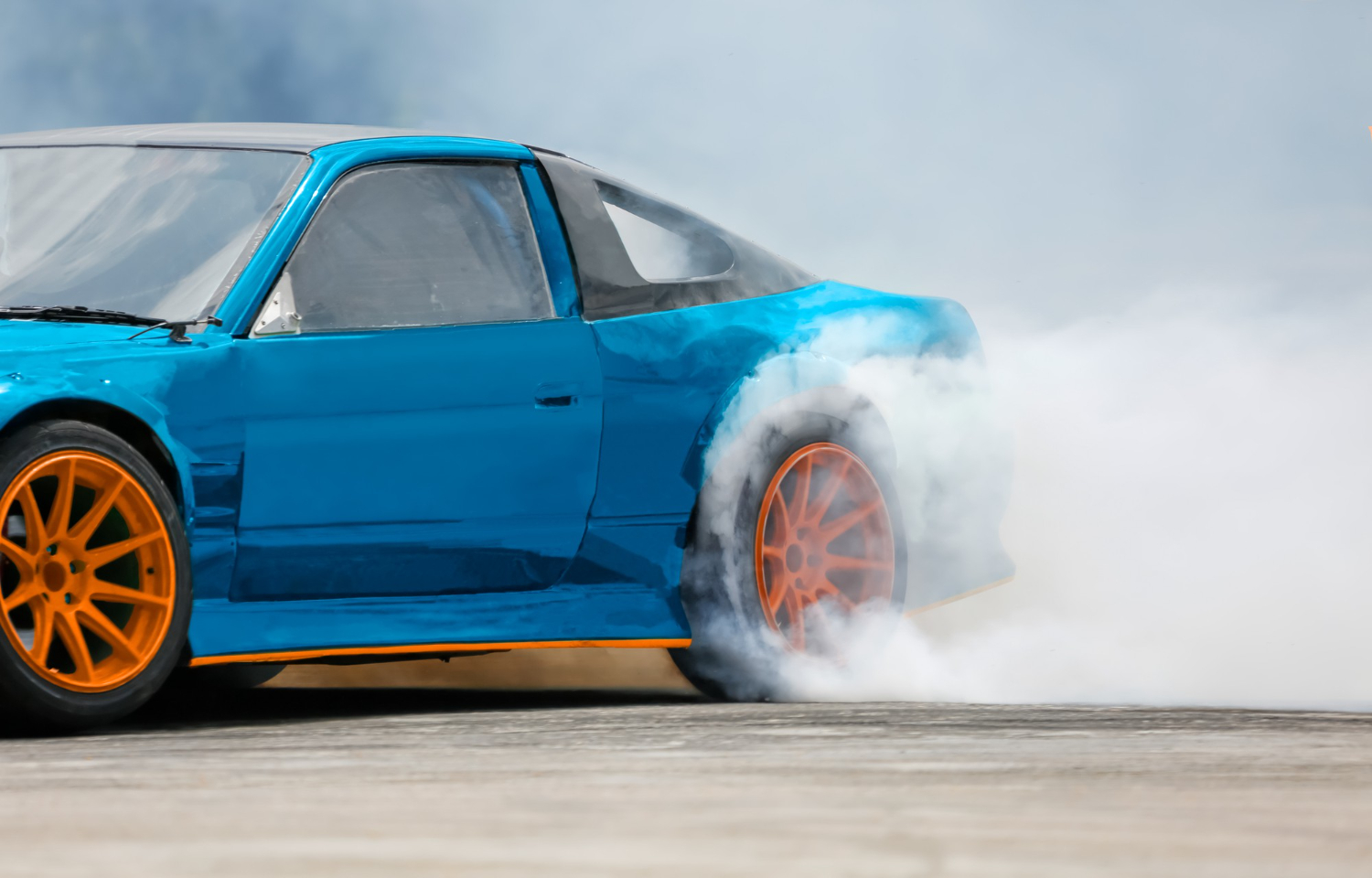 race car drifts burning tires on a speed track drag racing